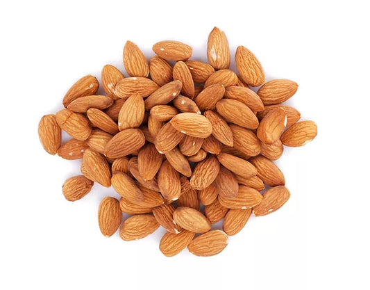 Pile of shelled almonds on a white background