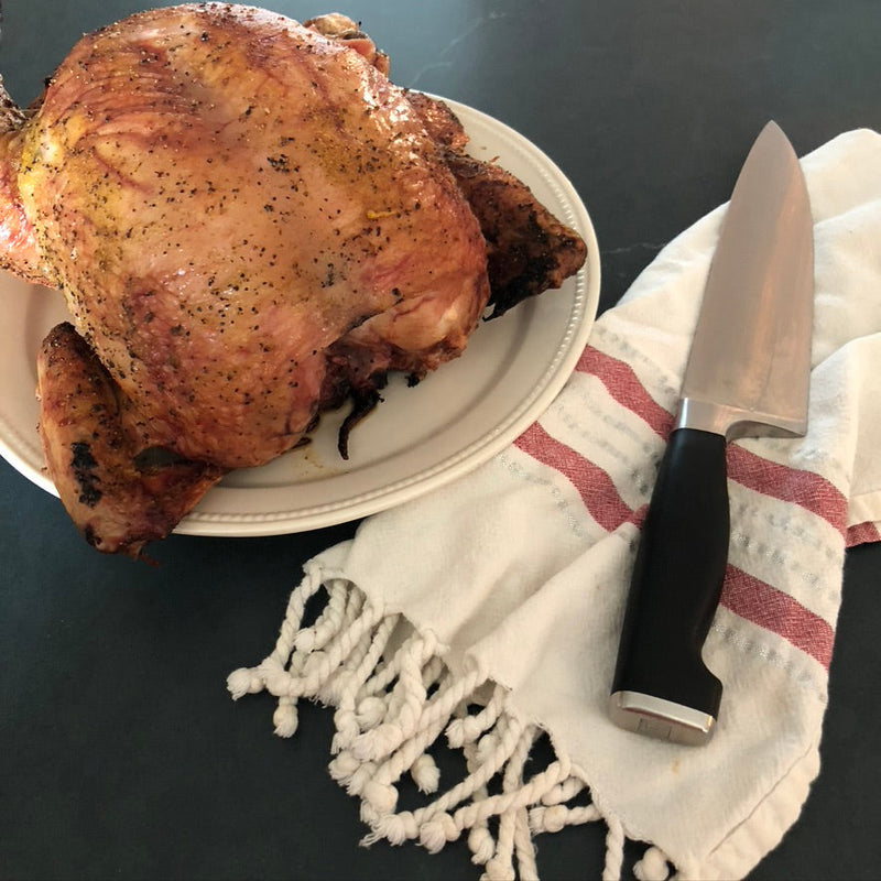 Roast chicken on a plate with a carving knife