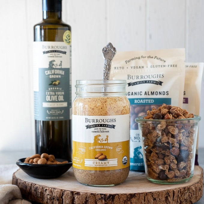Photo of various Burroughs Family Farm products like almond butter, almonds, and olive oil