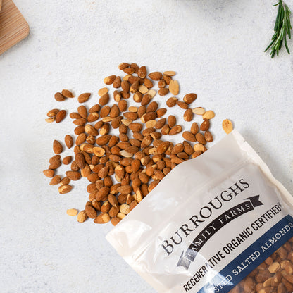 Roasted salted almonds spilling from an open bag
